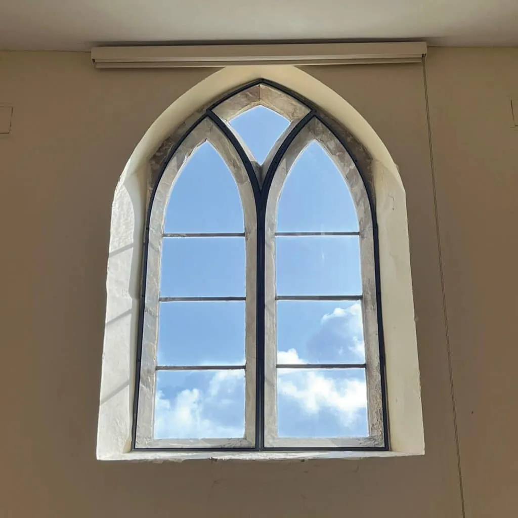 The team installed 12 shaped slimline units and 3 slimline units, all in a bespoke dark grey colour to fit the stone window surrounds. 
